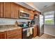 Kitchen featuring stainless steel appliances, granite counters, and wooden cabinets at 201 N Hillside Dr. # 311-A, North Myrtle Beach, SC 29582