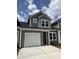 Two-story home featuring a single-car garage, gray siding, and manicured landscaping at 2076 Victory Way # 570, Myrtle Beach, SC 29579