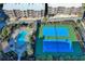 Aerial view of community, highlighting the pool, hot tub, and blue tennis courts at 208 N Ocean Blvd. # 321, North Myrtle Beach, SC 29582