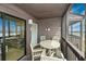 Covered balcony with seating area perfect for enjoying ocean views and coastal breezes at 208 N Ocean Blvd. # 321, North Myrtle Beach, SC 29582