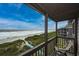 Inviting balcony with chair offering picturesque views of the ocean and coastline at 208 N Ocean Blvd. # 321, North Myrtle Beach, SC 29582