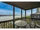 Relaxing balcony with a table and chairs overlooking the stunning ocean and sandy beach at 208 N Ocean Blvd. # 321, North Myrtle Beach, SC 29582