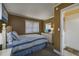 Cozy bedroom featuring a bed with striped bedding and a dresser, illuminated by natural light at 208 N Ocean Blvd. # 321, North Myrtle Beach, SC 29582