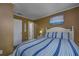 Inviting bedroom boasts striped bedding, nautical-themed décor, and a serene atmosphere for restful nights at 208 N Ocean Blvd. # 321, North Myrtle Beach, SC 29582
