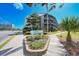 Landscaped entrance to Tilghman Beach and Racquet Club featuring mature trees and blooming flowers at 208 N Ocean Blvd. # 321, North Myrtle Beach, SC 29582
