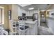 Updated kitchen with breakfast bar featuring granite counters, tile floors, and white cabinets at 208 N Ocean Blvd. # 321, North Myrtle Beach, SC 29582
