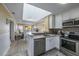Bright kitchen features white cabinets, stainless steel appliances, and granite countertops at 208 N Ocean Blvd. # 321, North Myrtle Beach, SC 29582