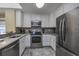 Well-equipped kitchen with white cabinets, stainless steel appliances, and tiled backsplash at 208 N Ocean Blvd. # 321, North Myrtle Beach, SC 29582