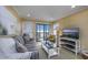 Comfortable living room with ocean views and a sliding glass door to a private balcony at 208 N Ocean Blvd. # 321, North Myrtle Beach, SC 29582