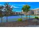 Exterior shot of community tennis courts, framed by trees and surrounding greenery at 208 N Ocean Blvd. # 321, North Myrtle Beach, SC 29582