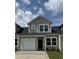 Charming townhome boasts a one-car garage and classic architectural details against a beautiful blue sky at 2086 Victory Way # 566, Myrtle Beach, SC 29579