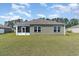 Spacious backyard with green lawn and view of the home's rear exterior at 211 Seasons Trace Loop, Longs, SC 29568