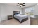Cozy bedroom features neutral walls, plush carpeting, ceiling fan, and a window that provides natural light at 211 Seasons Trace Loop, Longs, SC 29568