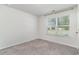 Bright bedroom with large window, neutral carpet, and ample natural light at 211 Seasons Trace Loop, Longs, SC 29568