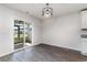 Bright dining area with sliding glass doors leading to the backyard, and a stylish chandelier that adds character at 211 Seasons Trace Loop, Longs, SC 29568