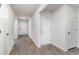Inviting hallway featuring neutral walls, wood-look floors and white doors that adds a touch of elegance to the home at 211 Seasons Trace Loop, Longs, SC 29568