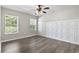 Bedroom featuring ceiling fan, hardwood floors, and paneled wall at 215 Carolina Farms Blvd., Myrtle Beach, SC 29579
