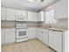 Bright kitchen features white appliances, cabinets, and tiled floor at 215 Carolina Farms Blvd., Myrtle Beach, SC 29579