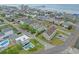 Aerial view of a beach neighborhood with houses, pools, and coastal charm at 215-B S Dogwood Dr., Surfside Beach, SC 29575
