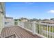Expansive balcony with white railings offers neighborhood views from this beach home at 215-B S Dogwood Dr., Surfside Beach, SC 29575