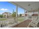 View from the balcony, overlooking neighboring houses, palm trees, and a blue sky at 215-B S Dogwood Dr., Surfside Beach, SC 29575