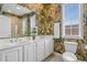 Well-lit bathroom featuring double sinks, a large mirror, and tropical-themed wallpaper at 215-B S Dogwood Dr., Surfside Beach, SC 29575