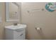 Cozy powder room featuring a classic white vanity, mirror, and beach-themed decor at 215-B S Dogwood Dr., Surfside Beach, SC 29575