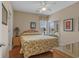 Bedroom with queen bed, hardwood floors, ceiling fan and side tables with lamps at 215-B S Dogwood Dr., Surfside Beach, SC 29575