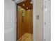 Interior view of a wood-paneled residential elevator showcasing its compact design and functionality at 215-B S Dogwood Dr., Surfside Beach, SC 29575