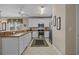 Modern kitchen with white cabinets, stainless steel appliances, and tile flooring at 215-B S Dogwood Dr., Surfside Beach, SC 29575