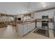 Bright open kitchen featuring white cabinetry, stainless steel appliances, and views of the adjacent living area at 215-B S Dogwood Dr., Surfside Beach, SC 29575