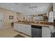 Kitchen view featuring an extended countertop bar and a stainless steel dishwasher at 215-B S Dogwood Dr., Surfside Beach, SC 29575