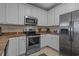 Updated kitchen featuring stainless steel appliances and white cabinetry at 215-B S Dogwood Dr., Surfside Beach, SC 29575