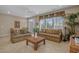 Relaxing living area with two sofas, a rattan coffee table, and bright windows at 215-B S Dogwood Dr., Surfside Beach, SC 29575