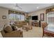 Inviting living space featuring cozy sofas, rattan accents, and natural lighting at 215-B S Dogwood Dr., Surfside Beach, SC 29575