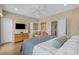 Spacious bedroom showcasing hard floors, a king bed, a dresser, and access to the en-suite bathroom at 215-B S Dogwood Dr., Surfside Beach, SC 29575