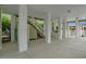 View of covered parking beneath a raised beach house with an outdoor shower and stairs to the main level at 215-B S Dogwood Dr., Surfside Beach, SC 29575