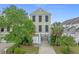 Attractive two-story home featuring a garage and driveway surrounded by mature landscaping at 215-B S Dogwood Dr., Surfside Beach, SC 29575
