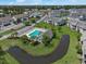 Aerial view of the community shows the layout with a pool, pond, landscaping, and building exteriors at 217 Wando River Rd. # 12-H, Myrtle Beach, SC 29579