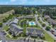 Community aerial showcases pool, pond, landscaping, nearby buildings, and surrounding wooded areas from above at 217 Wando River Rd. # 12-H, Myrtle Beach, SC 29579