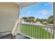 Relaxing balcony view of the community pool, surrounding landscape and condo exteriors on a beautiful day at 217 Wando River Rd. # 12-H, Myrtle Beach, SC 29579