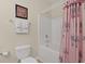 Bathtub and shower featuring framed artwork on the wall and tropical designed curtains at 217 Wando River Rd. # 12-H, Myrtle Beach, SC 29579