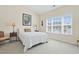 Cozy bedroom with a queen bed, neutral walls, and natural light from the window with plantation blinds at 217 Wando River Rd. # 12-H, Myrtle Beach, SC 29579