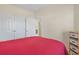 Bedroom featuring a red quilt bed with white trim with doorway views to bathroom at 217 Wando River Rd. # 12-H, Myrtle Beach, SC 29579