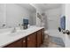 Bathroom featuring a single sink vanity, a tub-shower with a decorative curtain and a tile floor with rug at 2170 Buxton Dr., Myrtle Beach, SC 29579