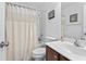 Well-lit bathroom featuring a vanity with a dark wood cabinet and a shower-tub combo with a decorative shower curtain at 2170 Buxton Dr., Myrtle Beach, SC 29579