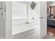 Bathroom featuring a bright, white bathtub, with natural light from a window, and hardwood floors at 2170 Buxton Dr., Myrtle Beach, SC 29579