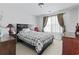 Bedroom showcasing a bed with a patterned comforter, complemented by dark wood furniture and window with decorative curtains at 2170 Buxton Dr., Myrtle Beach, SC 29579