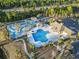 Wide aerial shot displays community pool, clubhouse, play areas, palm trees and other amenities at 2170 Buxton Dr., Myrtle Beach, SC 29579