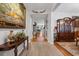 Elegant foyer featuring hardwood floors, decorative vases, artwork, and intricate wood furniture at 2170 Buxton Dr., Myrtle Beach, SC 29579
